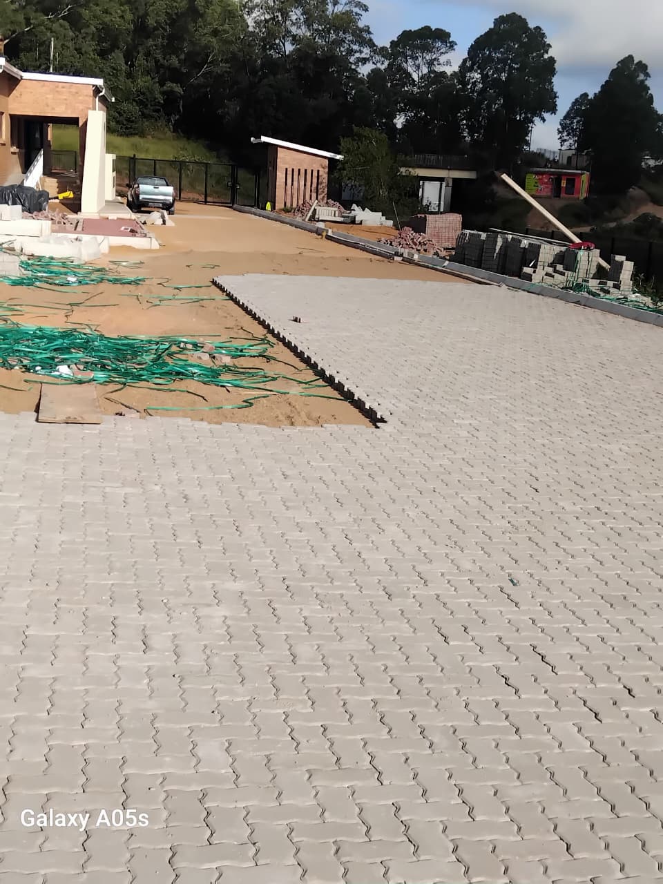 Large grey interlocking paved courtyard area next to face brick buildings