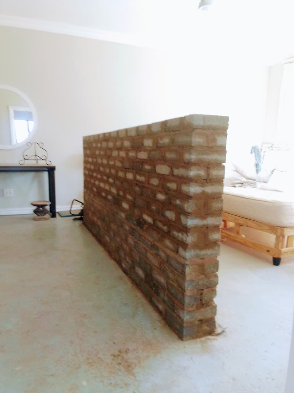 New interior masonry wall built inside an existing room